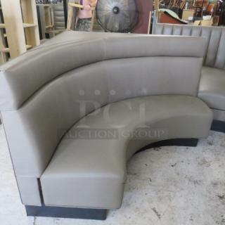 Corner rounded booth with gray cushions, dimensions 60x27x42, featuring a sleek design and in good condition.
