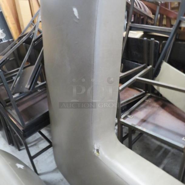 Gray corner booth with cushions, dimensions 58x27x42 inches. Features visible tears on the seat.