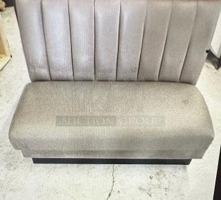 Single-sided booth with grey cushioned seat and back. Vertical stitching on backrest. Used condition, no visible tags.