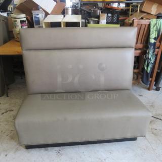 Single-sided booth with grey cushioned seat and back, 48x27x45 inches, in used condition.