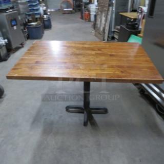 Solid wood butcher block table, 48x30x30, with sturdy pedestal base. Excellent condition with natural wood grain finish.