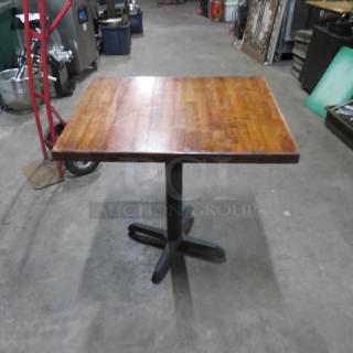 Solid wood butcher block table with pedestal base, 24x30x30 inches. Smooth finish, well-maintained condition.
