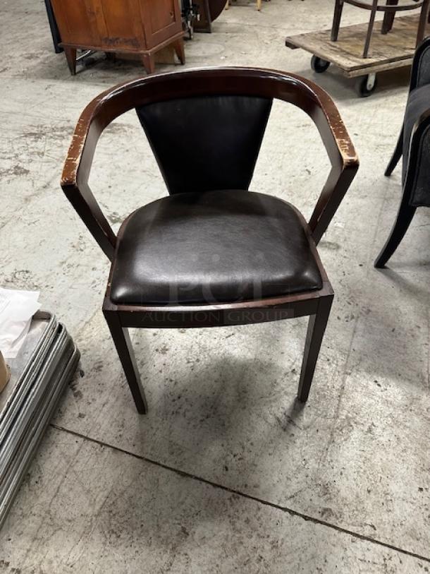 Wooden chair with brown cushioned seat and back, visible wear on armrests, in used condition, model 2XBID.