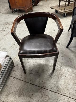 Wooden chair with brown cushioned seat and back, visible wear on armrests, in used condition, model 2XBID.