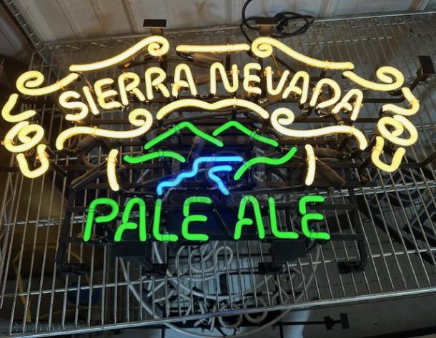 Sierra Nevada Pale Ale neon sign, with yellow and green text, swirling design, in working condition.