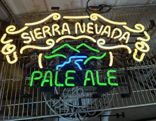 Sierra Nevada Pale Ale neon sign, with yellow and green text, swirling design, in working condition.