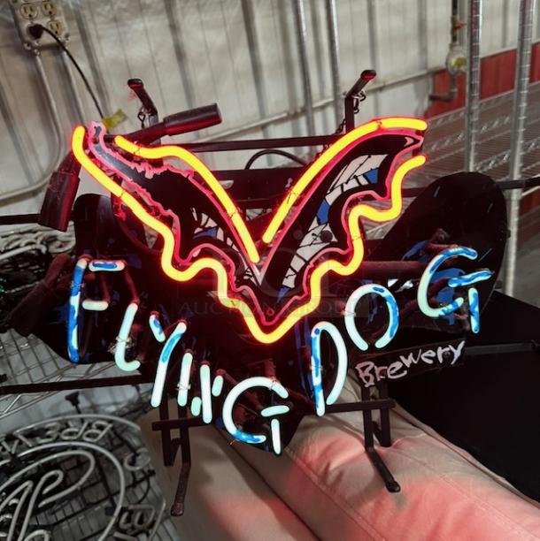 Neon sign for Flying Dog Brewery with bright colors and unique design, in working condition.
