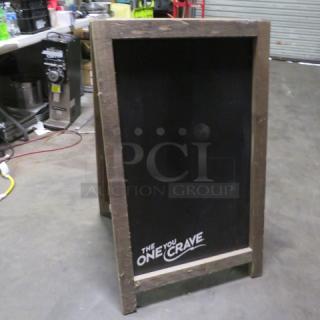 Wooden framed chalkboard sidewalk sign, "The One You Crave" text, 23.5x39 inches, rustic condition.