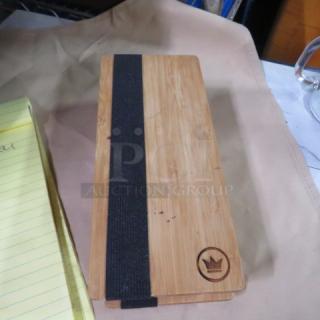Wooden guest check holder with a black band and crown emblem, model 8XBID. Appears in good condition with light wear.
