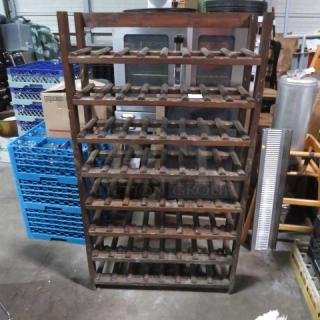 Wooden wine bottle holder for 64 bottles, measures 31x11x55 inches, durable wooden construction, used condition.