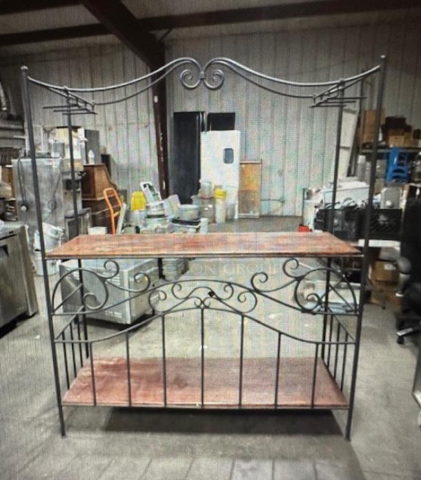 Decorative wine bar with metal frame, two wooden shelves, and wine glass racks, measuring 60x22x70. Intricate scrollwork design.