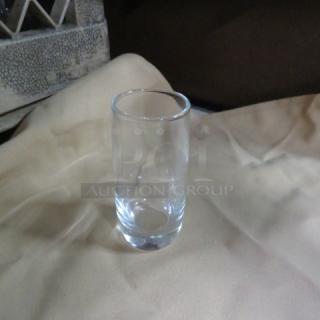 Clear 2oz shot glass, new condition, plain design. No visible markings or labels.
