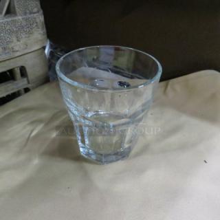 Clear glass rocks glass with a faceted design, good condition, no visible markings or labels, approximately 4 inches tall.