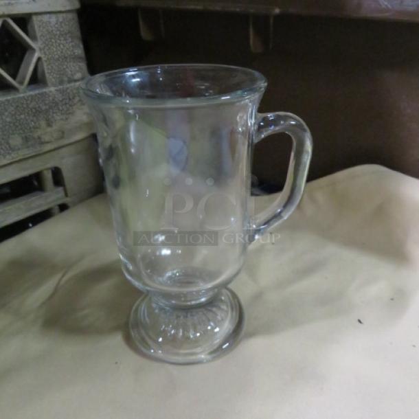 Clear glass Irish coffee mug, pedestal base, ergonomic handle, gently used, no visible marks or chips. Model: 12XBID.