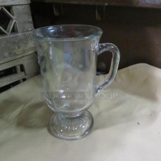 Clear glass Irish coffee mug, pedestal base, ergonomic handle, gently used, no visible marks or chips. Model: 12XBID.
