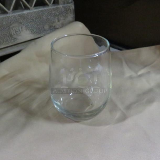Clear stemless wine glass, gently curved design, smooth rim, excellent condition. Item code: 12XBID.