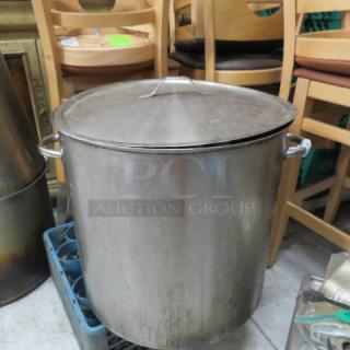 Stainless steel heavy-duty stock pot with lid, 20x20 inches, used condition. Features sturdy side handles.
