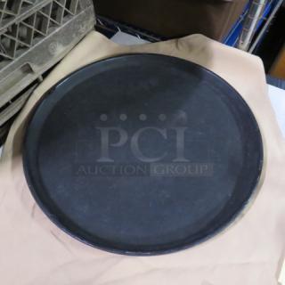 16-inch black waitress tray, circular with slight edge; used condition, suitable for food service or decor.