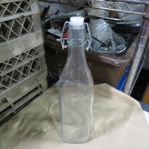 Clear glass water bottle with hinged lid, 10XBID model. Rectangular shape, pristine condition. Ideal for storage.