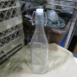 Clear glass water bottle with hinged lid, 10XBID model. Rectangular shape, pristine condition. Ideal for storage.
