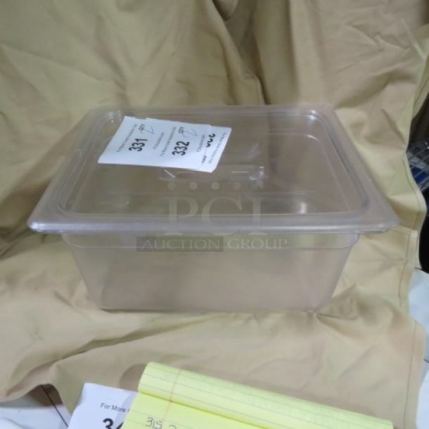 1/2 Size 6-inch deep food storage container with lid, clear plastic, new condition, auction tag 2XBID visible on lid.
