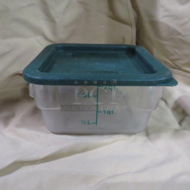 Square 2-quart food storage container with green lid, clear plastic body, marked with volume measurements in quarts and liters.