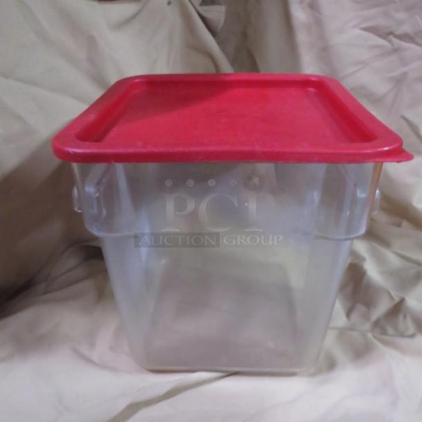 Clear 8 quart food storage container with red lid, used condition. Visible attached handles for secure sealing.