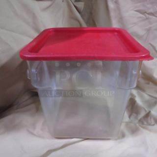 Clear 8 quart food storage container with red lid, used condition. Visible attached handles for secure sealing.
