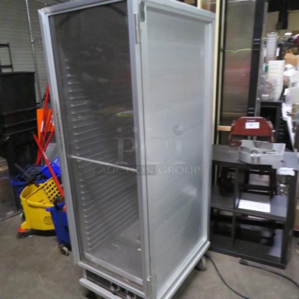Adcraft Heat and Hold on casters, 20.5"x31"x67", in working condition. Silver exterior with visible interior shelving.