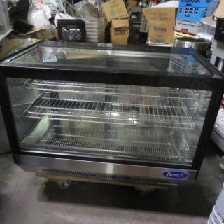 Atosa refrigerated countertop display cooler, 36x22x27 inches, features two racks, glass front, and steel finish.