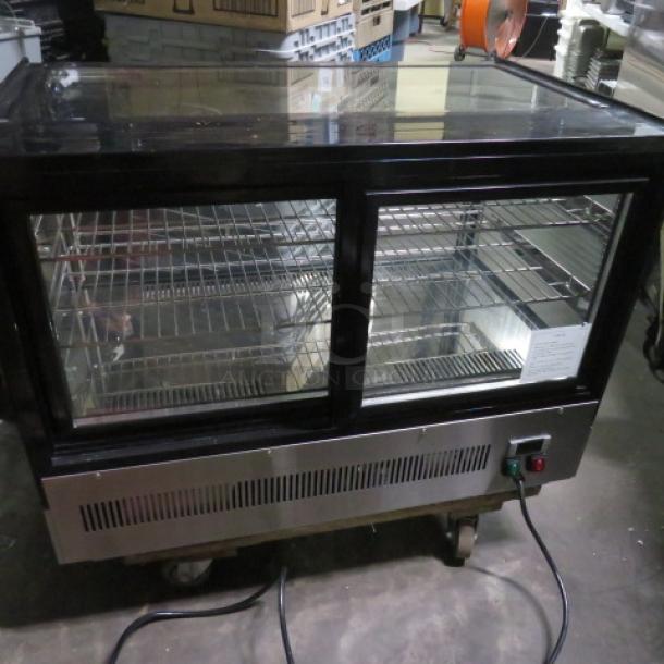 Atosa refrigerated countertop display cooler, 36x22x27 inches, two racks, glass front, price tag visible, excellent condition.