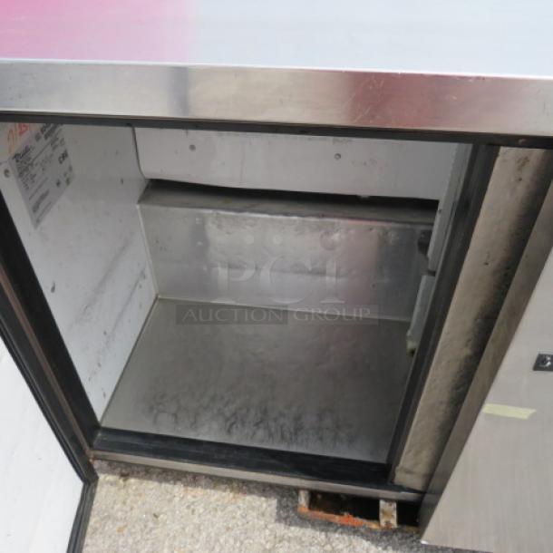True TUC-48F two-door worktop freezer on casters, stainless steel, 48x31x35.5 inches, 115V. Open door showing interior.
