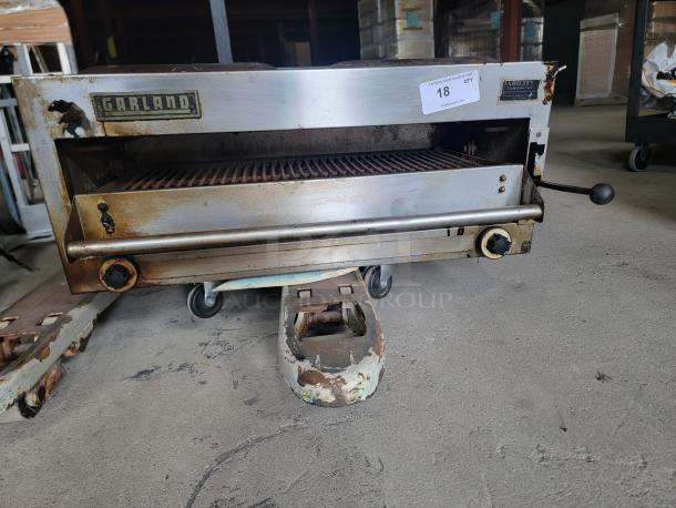 Vintage Garland commercial broiler grill, stainless steel, visible rust and wear, condition fair, auction lot tag 18 attached.