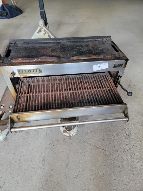 Vintage Garland gas grill with pull-out grate, moderate rust, and wear. Label indicates model "Grille Master." Auction tag "18."