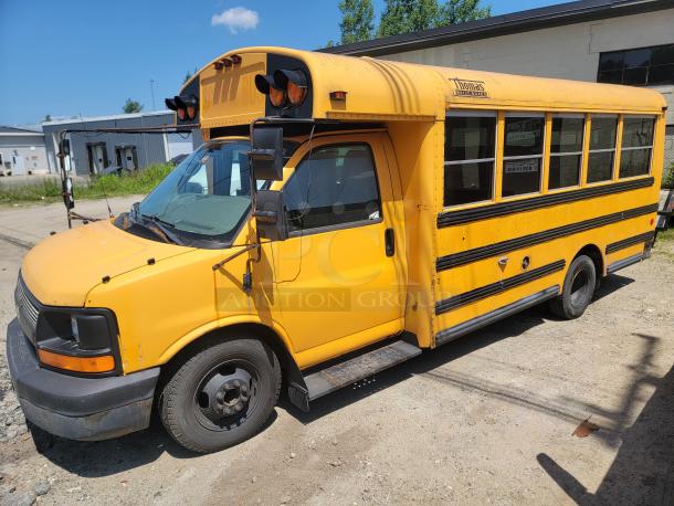Yellow mini school bus with "Thomas Built Buses" logo, showing wear. Side reads "Jaffrey Rindge School District."