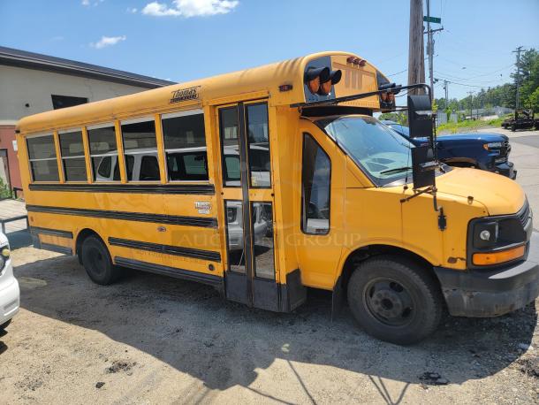 Yellow Thomas Minotour school bus, used condition, visible wear on exterior. Clear "Thomas" brand logo on side.