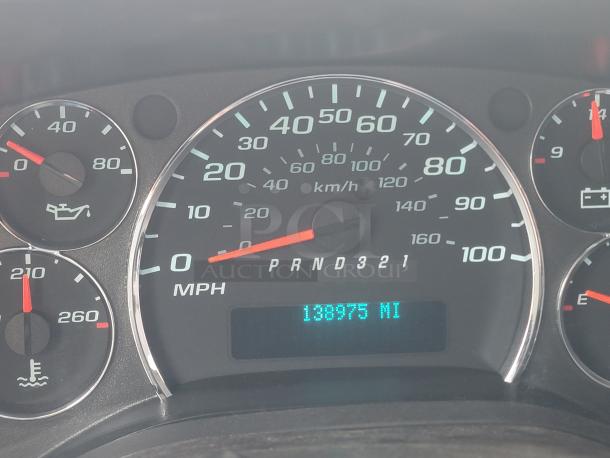 Car dashboard displaying 138,975 miles, speedometer in MPH and km/h, oil and temperature gauges.