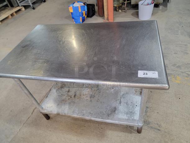 Stainless Steel Work Table - Heavy Duty! Get this sturdy 4-foot stainless steel work table! Perfect for kitchens, garages, workshops, or any commercial space. Durable metal base. - Image 1 of 2