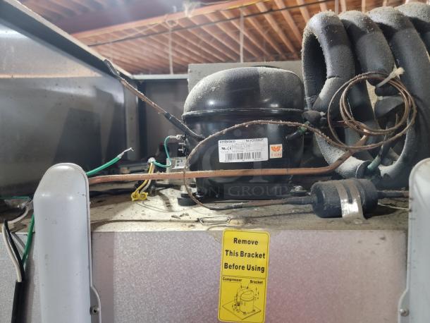 Atosa MBF8001GR commercial freezer, not powering on, suspected electrical issue, for parts/repair. Visible compressor and wiring.