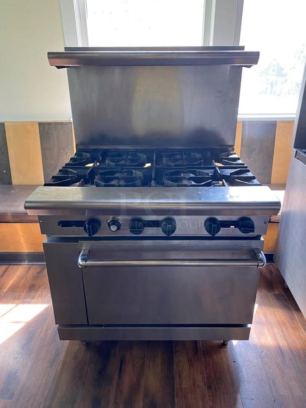 Commercial Gas Range - 4 Burners with Oven! Supercharge your kitchen's cooking capabilities with this robust and reliable commercial gas range! This professional-grade unit features four powerful open-top burners and a spacious full-size oven below, making it an essential appliance for any busy restaurant, diner, catering business, or commercial kitchen looking for versatile and efficient cooking. - Image 1 of 2
