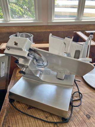 Univex Commercial Meat Slicer - Missing Knob - Great Value! This heavy-duty unit is designed for consistent, precise slicing of meats, cheeses, and vegetables, even with a minor cosmetic issue. - Item #1194841