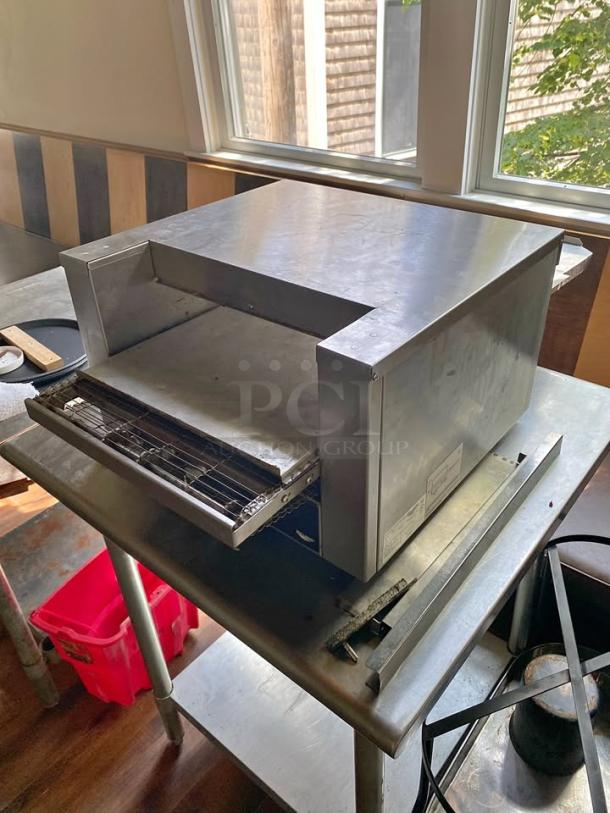 Vollrath JB3H Commercial Toaster/Finisher!  This stainless steel electric unit is perfect for quickly toasting bread, bagels, and buns, melting cheese on sandwiches, finishing casseroles, or warming various food items. Its compact countertop design makes it ideal for restaurants, cafes, delis, or concession stands with limited space. - Image 1 of 3