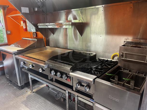 Fully equipped 2014 Quality Trailers mobile kitchen, 20'L x 8'5"W, includes grill, fryer, and hood in excellent condition.