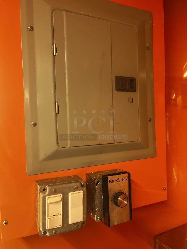 Electric panel and Vari-Speed control system in a 2014 Quality Trailers mobile kitchen. Panel and switches in good condition.