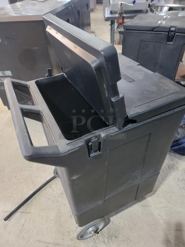 Carlisle 175lb mobile ice caddie, durable black plastic, hinged lid, attached wheels, optimal for easy transport.