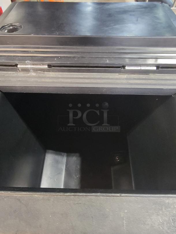 Carlisle 175lb mobile ice caddie, black, used, open top view. Durable plastic with visible interior. Ideal for catering.