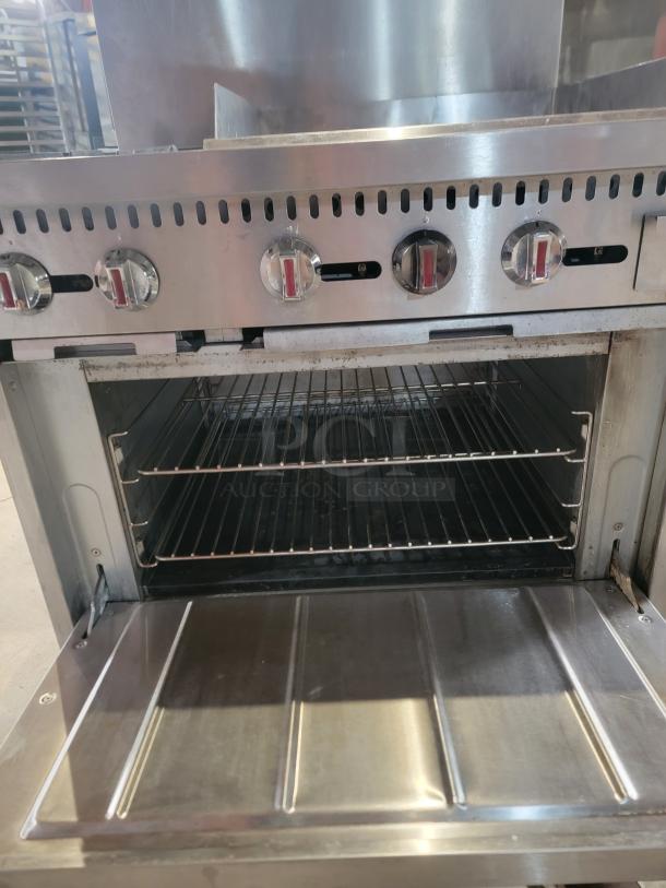 Kintera K2G24 commercial gas range featuring two burners, a 24" griddle, and a full-size oven. Robust and suitable for busy kitchens.