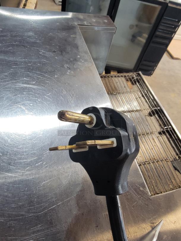 Vollrath JB3H commercial toaster/finisher with stainless steel body, visible power plug, compact design, ideal for small spaces.