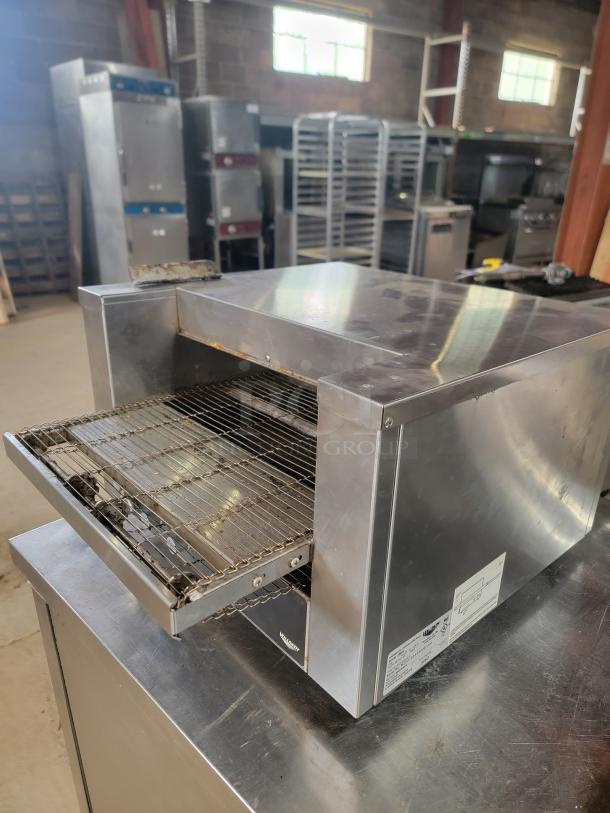 Vollrath JB3H stainless steel commercial toaster/finisher. Compact countertop design, perfect for restaurants. Visible label.