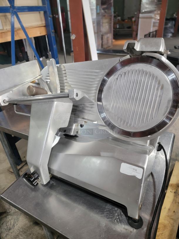 Univex commercial meat slicer, heavy-duty, missing knob, excellent for meats, cheeses, and vegetables, great condition.